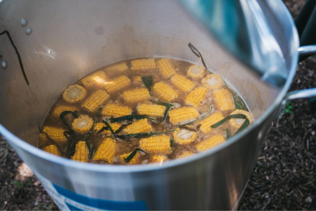 pot of boiling pieces of organic corn on the cob
